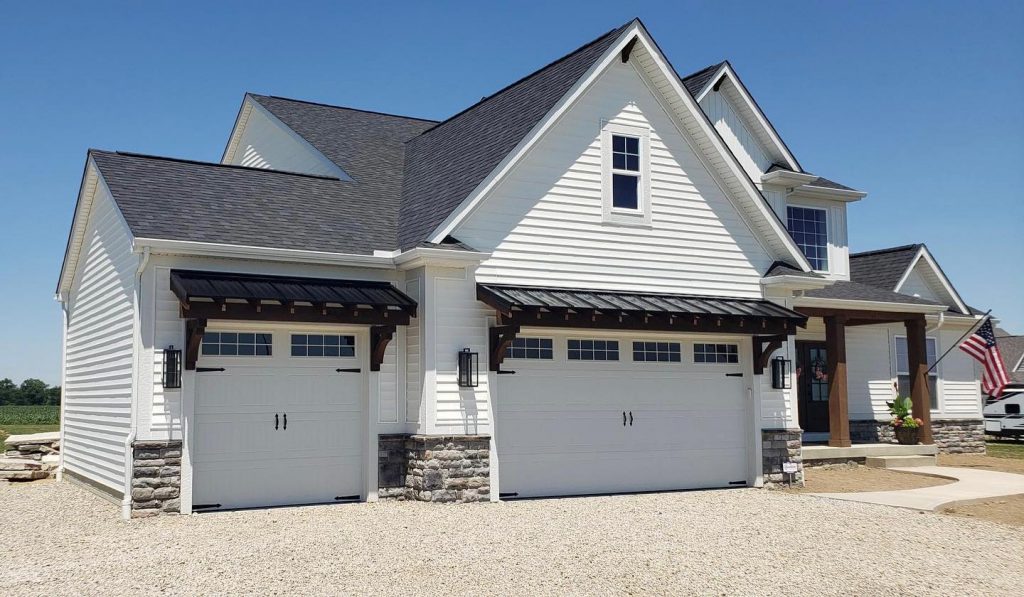 A beautiful white house with a professionally installed roof